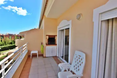 a balcony of a house with two chairs at ViaMar Apartment in Vilamoura