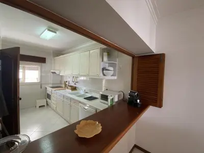 a kitchen with white cabinets and a counter top at Vilamoura Garden View 2 With Pool by Homing in Vilamoura