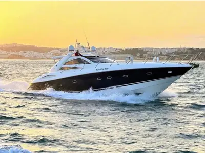 a black and white boat in the water at White & Nature Apartment in Vilamoura