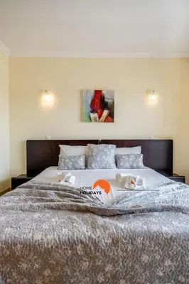 a bedroom with a large bed with two stuffed animals on it at #160 V3 Vila Branca 92 by Home Holidays in Albufeira