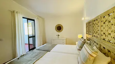 a bedroom with a large bed and a window at Neridas Villa by Check-in Portugal in Quarteira