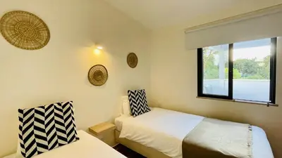 a bedroom with two beds and a window at Neridas Villa by Check-in Portugal in Quarteira