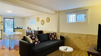 a living room with a couch and a table at Neridas Villa by Check-in Portugal in Quarteira