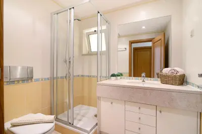 a bathroom with a shower and a toilet and a sink at Vilamoura Marina in Vilamoura