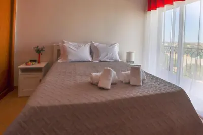 a bedroom with a bed with two towels on it at Apart ALGARVE - Piscina - BY BEDZY in Albufeira
