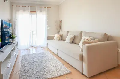 a living room with a couch and a television at Apart ALGARVE - Piscina - BY BEDZY in Albufeira