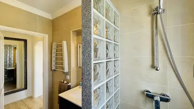 a bathroom with a shower with a glass block wall at Jardim da Oura by Check-in Portugal in Albufeira