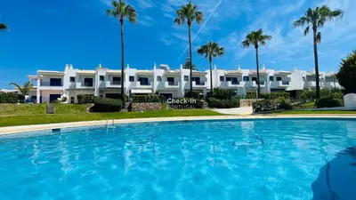 a large swimming pool in front of a large white building at Jardim da Oura by Check-in Portugal in Albufeira
