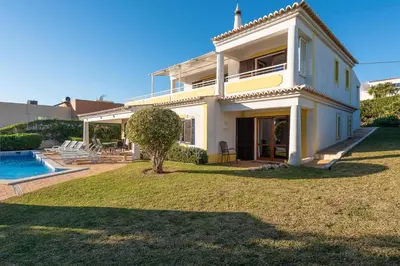 a large white house with a yard and a swimming pool at Villa Andrea by Gabi Miguel in Albufeira