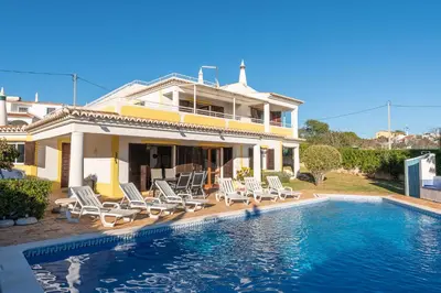 a house with a swimming pool in front of a house at Villa Andrea by Gabi Miguel in Albufeira