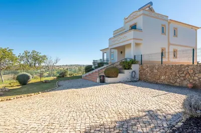 a large white house with a stone driveway at Villa Agua by Gabi Miguel in Albufeira