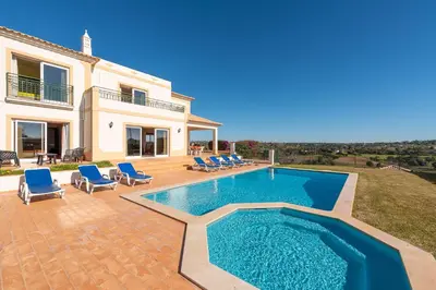 a villa with a swimming pool in front of a house at Villa Agua by Gabi Miguel in Albufeira