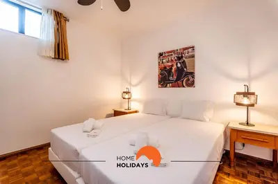 a bedroom with a large white bed and two lamps at #158 T3 Panorama C by Home Holidays in Albufeira