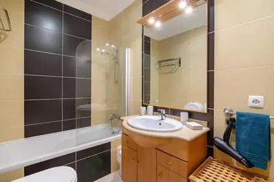 a bathroom with a sink and a toilet and a shower at T2 Encosta São José by Gabi Miguel in Guia