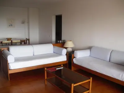 a living room with two white couches and a table at Aparthotel Dom Pedro Portobelo in Vilamoura