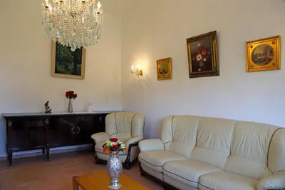 a living room with two couches and a chandelier at Sunset Pôr do sol in Galé