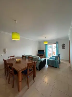 a living room with a table and a couch at Apartamento Falésia c/ Piscina in Albufeira