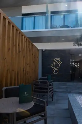 a restaurant with tables and chairs and a sign on a wall at Ria Formosa Guest House in Faro
