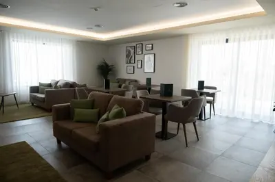a living room with a couch and chairs and tables at Ria Formosa Guest House in Faro
