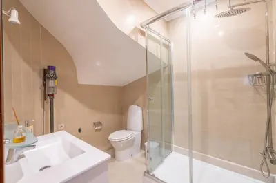 a bathroom with a shower and a sink and a toilet at Sunshine Holiday House in Quarteira