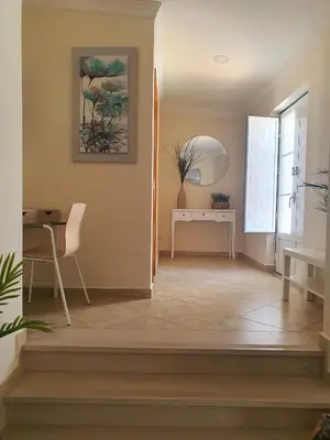 a living room with a table and a window at Casa da Vera in Faro