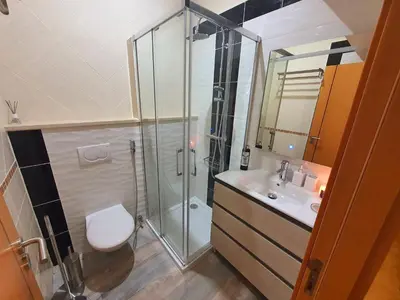 a bathroom with a shower and a toilet and a sink at Casa da Vera in Faro