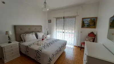 a bedroom with a large bed and a window at Albufeira Traditional Apartments IN VILLA in Albufeira