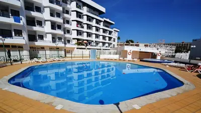a large swimming pool in front of a building at T3 Olhos de Água in Albufeira