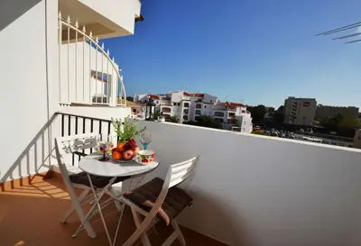 a balcony with a table and chairs on a balcony at T3 Olhos de Água in Albufeira