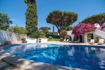 a swimming pool in a villa with trees at Traditional 3 bedroom villa with great pool in the heart of Vale do Lobo in Vale do Lobo
