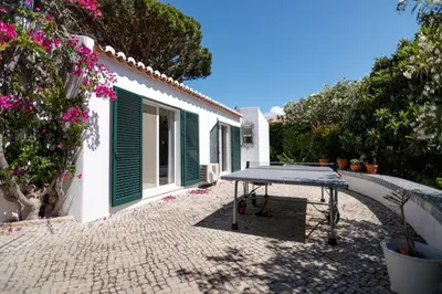 a table in the courtyard of a house at Traditional 3 bedroom villa with great pool in the heart of Vale do Lobo in Vale do Lobo