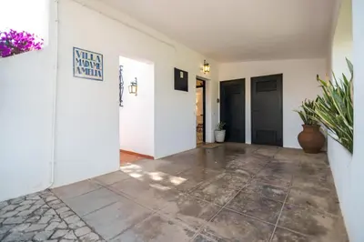 a hallway with white walls and a tile floor at Traditional 3 bedroom villa with great pool in the heart of Vale do Lobo in Vale do Lobo