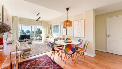 a living room with a table and chairs at Design Top Floor With Balcony & Pool in Vilamoura