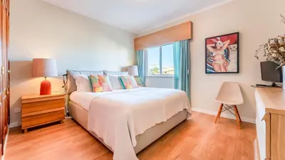 a bedroom with a bed and a window at Design Top Floor With Balcony & Pool in Vilamoura