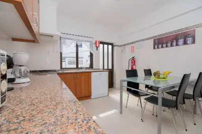 a kitchen with a table and chairs in a room at Avo Isabel by Innkeeper in Guia