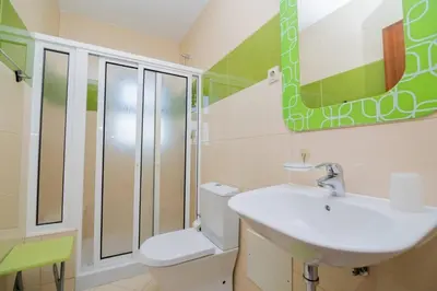 a bathroom with a sink and a toilet and a mirror at Avo Isabel by Innkeeper in Guia