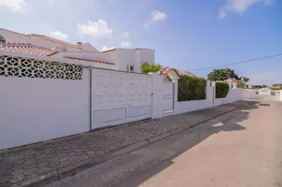 a white house with a white fence and a driveway at Avo Vitoria by Innkeeper in Guia