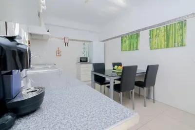 a kitchen with a table and chairs in a room at Avo Vitoria by Innkeeper in Guia