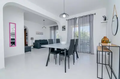 a dining room and living room with a table and chairs at Galé Igor by Innkeeper in Guia