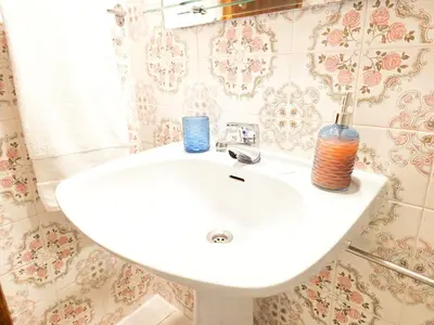 a table with two plates and a basket on it at Corte Real Apartment AE - Sea & Old Town View in Albufeira