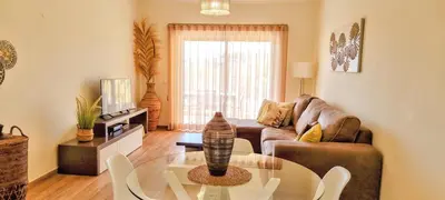 a living room with a couch and a table at Superbe Paradis dans les Jardins de la Marina in Albufeira
