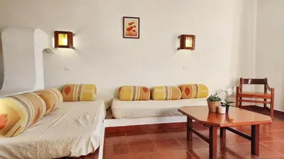 a living room with two beds and a table at Bright apartment with sea view in Albufeira - 67 m² + pool in Albufeira