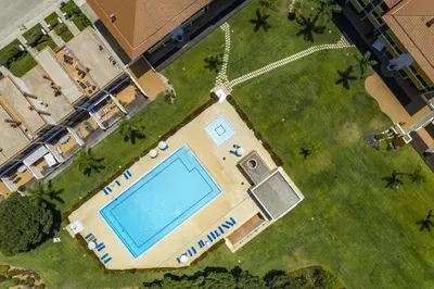 an overhead view of a swimming pool in a yard at Central Algarve Duplex Retreat with Garden & Pool in Quarteira