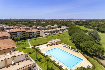 an aerial view of a resort with a swimming pool at Central Algarve Duplex Retreat with Garden & Pool in Quarteira