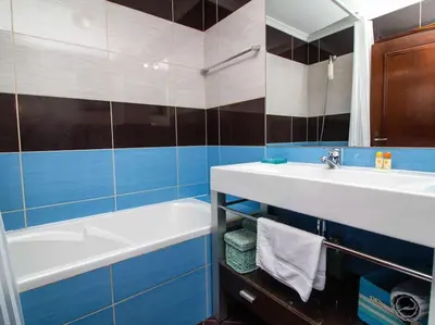 a bathroom with a sink and a bath tub at Vilamoura Marina Apartment by Stay ici Algarve Holiday Rental in Quarteira