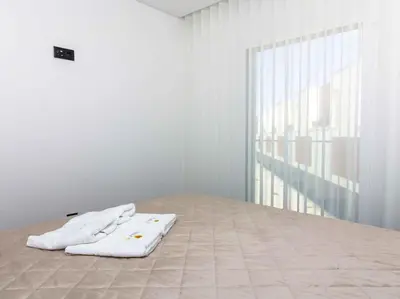 two white towels sitting on a bed in a room at Sea la Vie House by Stay ici Algarve Holiday Rental in Albufeira