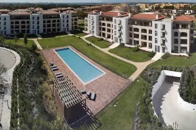 an aerial view of an apartment complex with a swimming pool at Gardens Dubai by FHR in Vilamoura