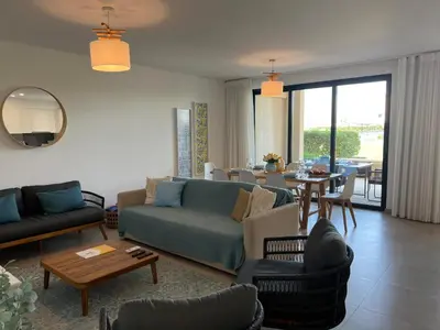 a living room with a couch and a table at Gardens Dubai by FHR in Vilamoura
