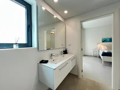 a bathroom with a sink and a mirror at Gardens Dubai by FHR in Vilamoura