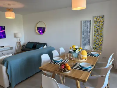 a dining room with a table and chairs at Gardens Dubai by FHR in Vilamoura